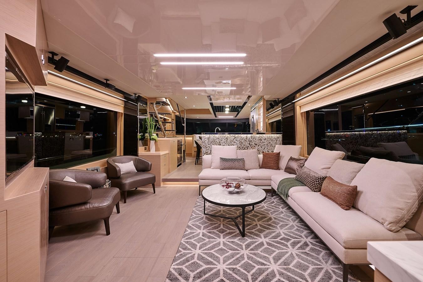 a living room with a large white couch and a round coffee table aboard V68 (NEW BOAT SPEC)  Yacht for Sale