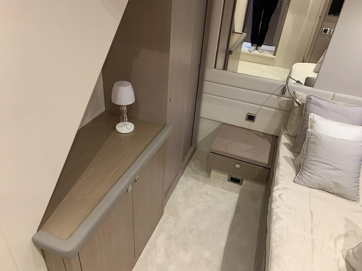 a bedroom with a bed and a desk aboard AHAVA Yacht for Sale