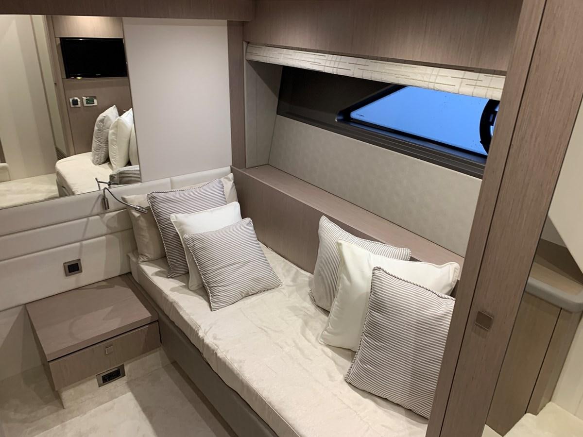 a bed with a window aboard AHAVA Yacht for Sale