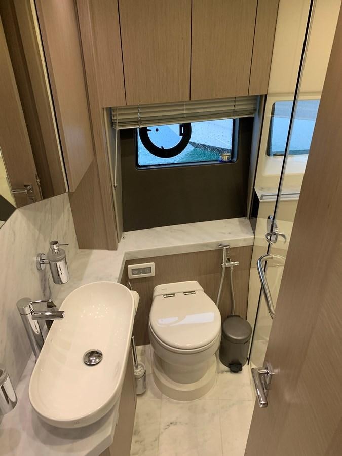 a bathroom with a toilet and a sink aboard AHAVA Yacht for Sale
