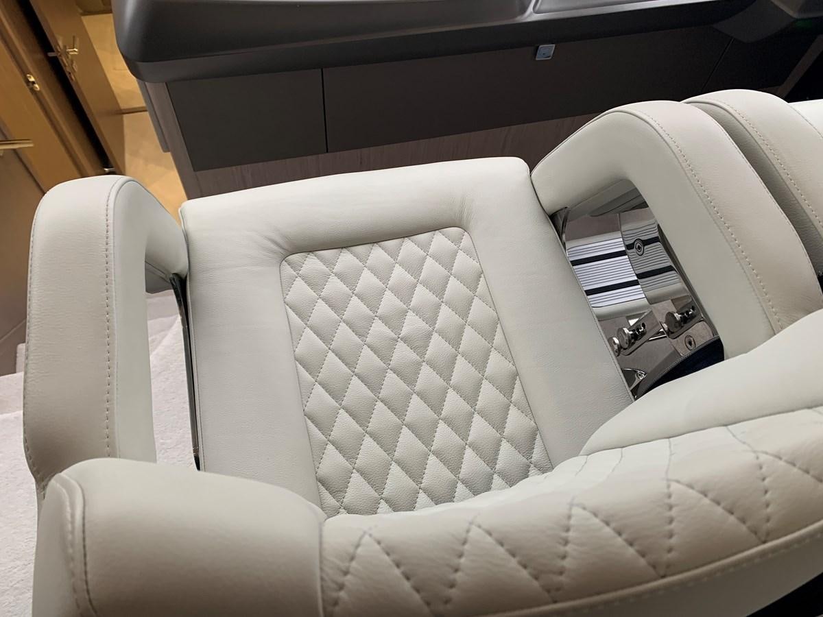 a white leather chair aboard AHAVA Yacht for Sale