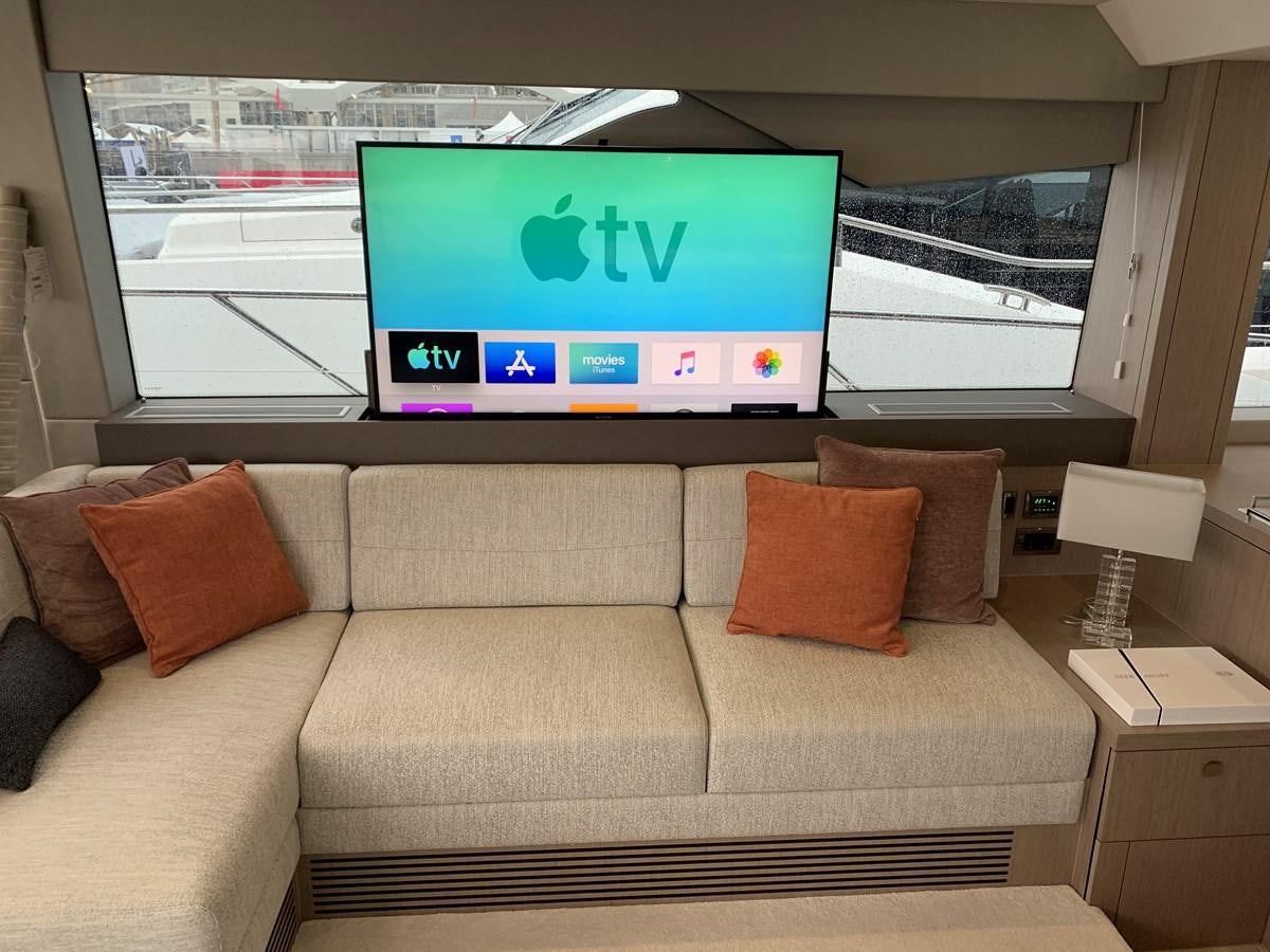 a couch with a tv on it aboard AHAVA Yacht for Sale