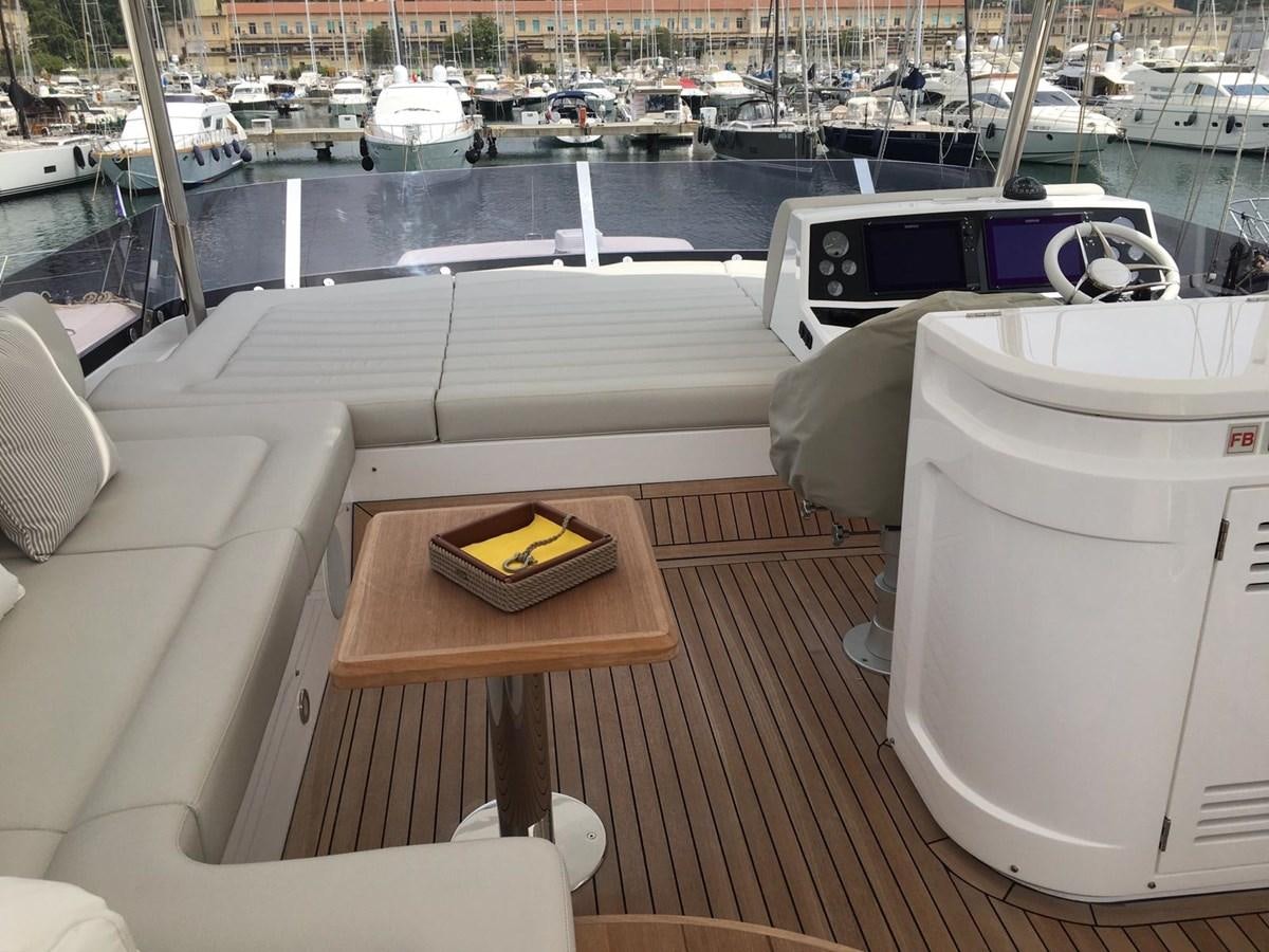 a table with chairs on it next to a body of water aboard AHAVA Yacht for Sale