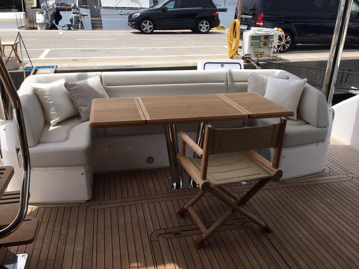 a table and chairs on a deck aboard AHAVA Yacht for Sale