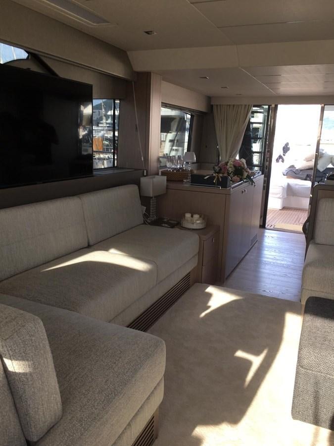 a living room with a couch and a tv aboard AHAVA Yacht for Sale