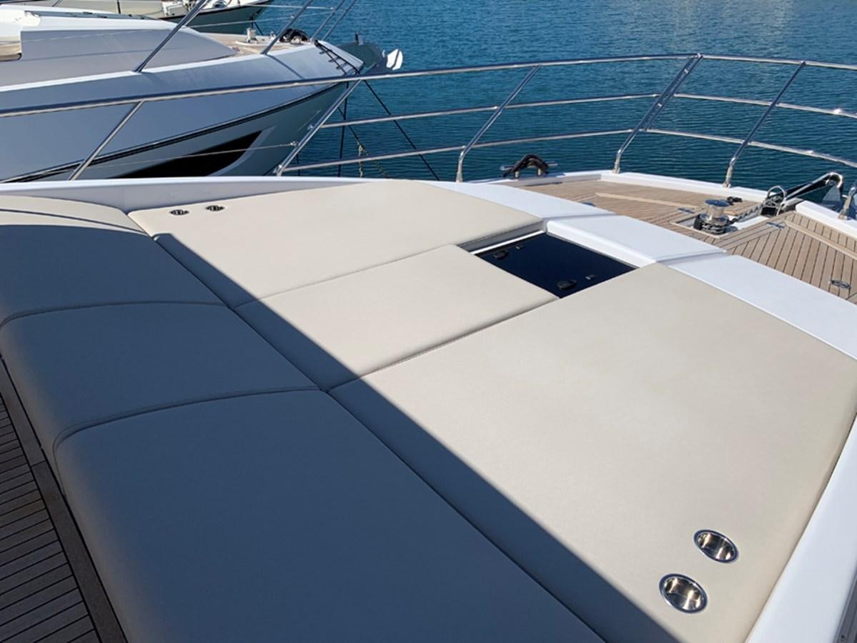 a white boat with a blue stripe aboard IMAGINE Yacht for Sale