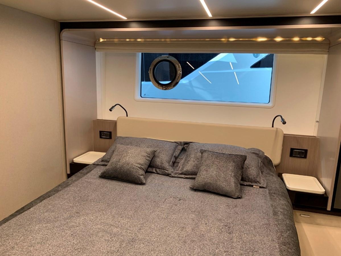 a bed with a large blue screen aboard IMAGINE Yacht for Sale