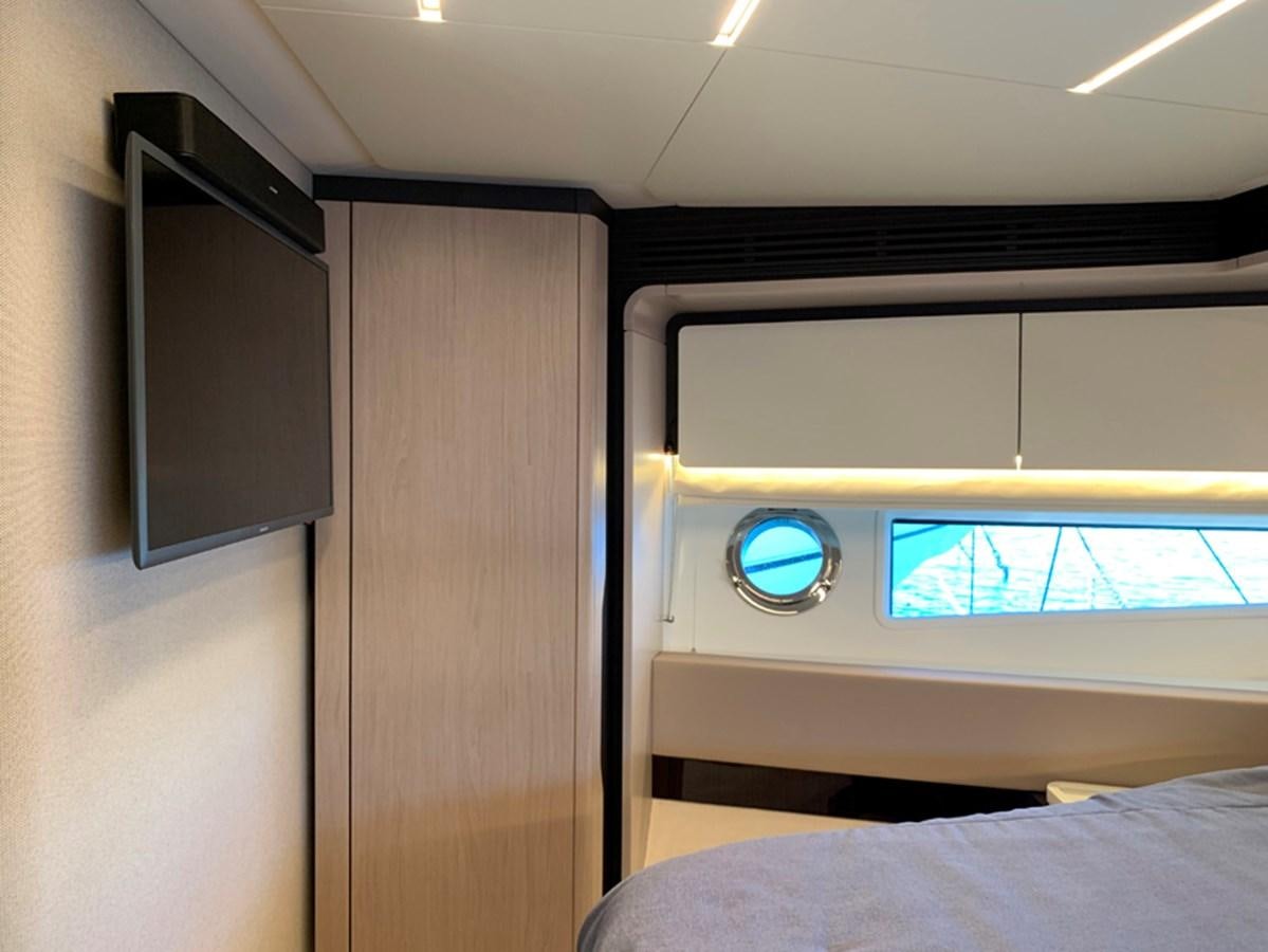 a room with a bed and a tv aboard IMAGINE Yacht for Sale