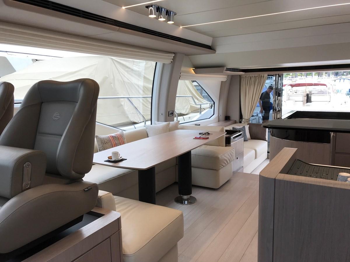 a room with a table and chairs aboard IMAGINE Yacht for Sale