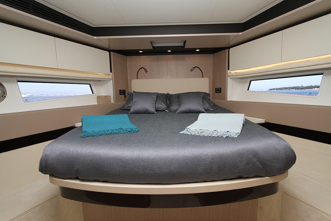 a bed with pillows on it aboard IMAGINE Yacht for Sale
