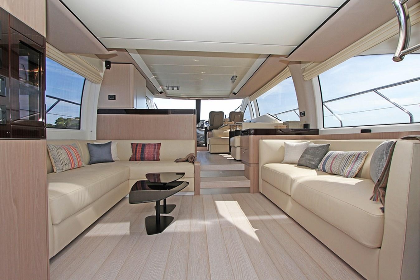 a living room with a couch and a coffee table aboard IMAGINE Yacht for Sale