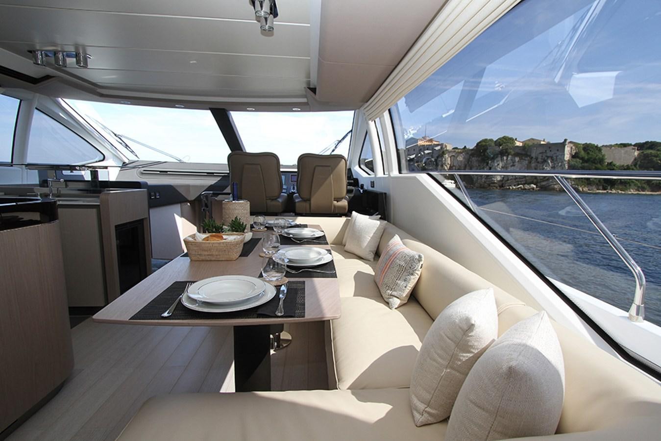 a table and chairs on a boat aboard IMAGINE Yacht for Sale