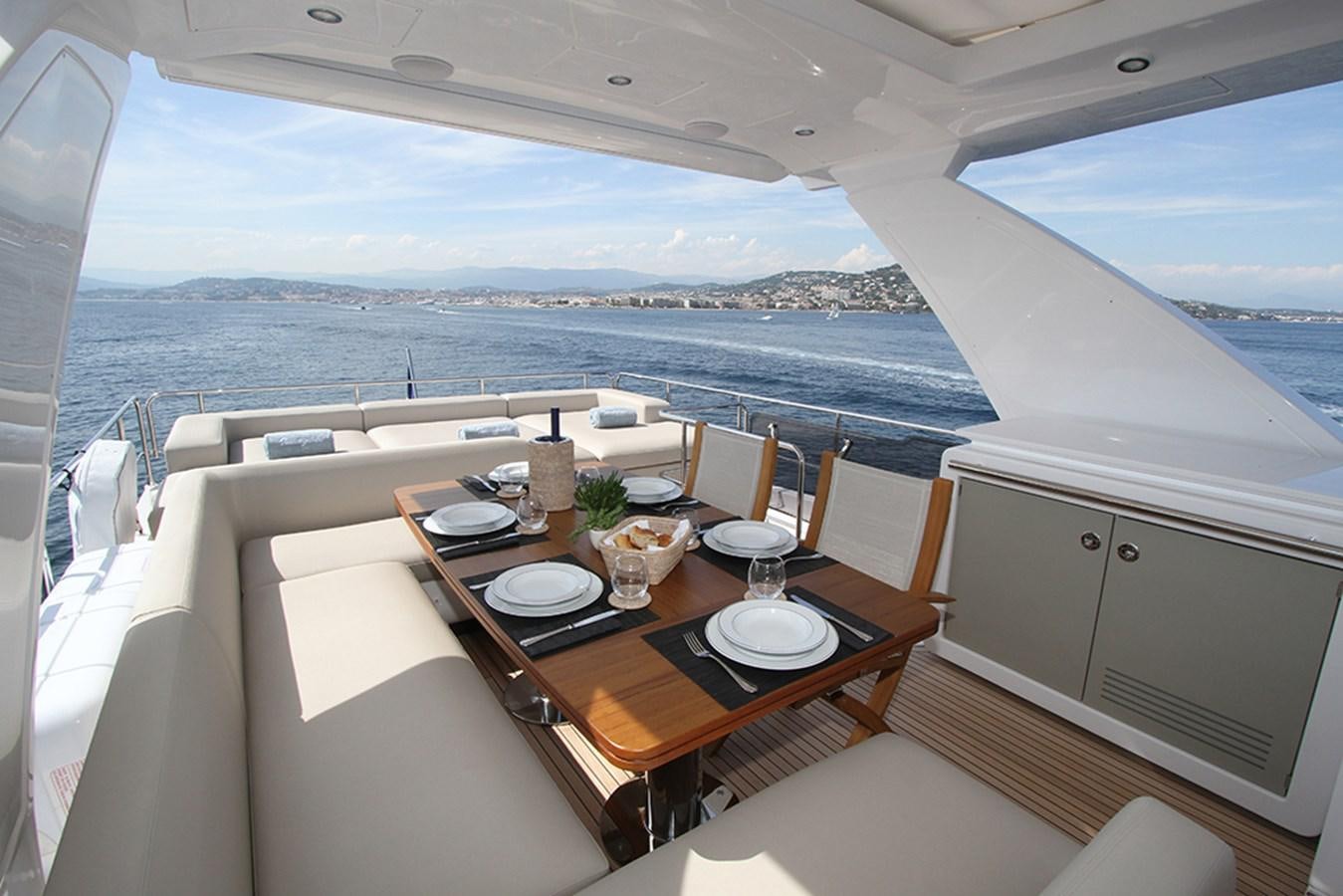 a table with plates and glasses on it aboard IMAGINE Yacht for Sale