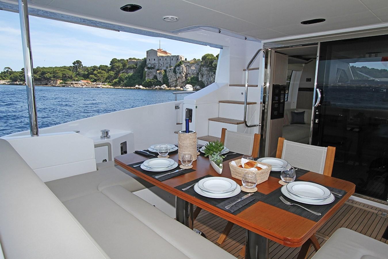 a table with plates and glasses on it aboard IMAGINE Yacht for Sale