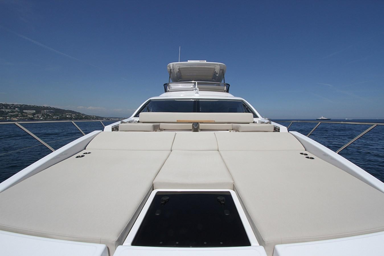a white yacht on a dock aboard IMAGINE Yacht for Sale