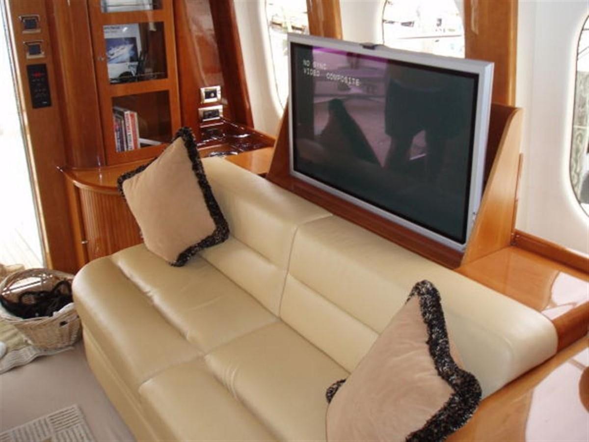 a living room with a tv aboard FOREVER SUMMER Yacht for Sale