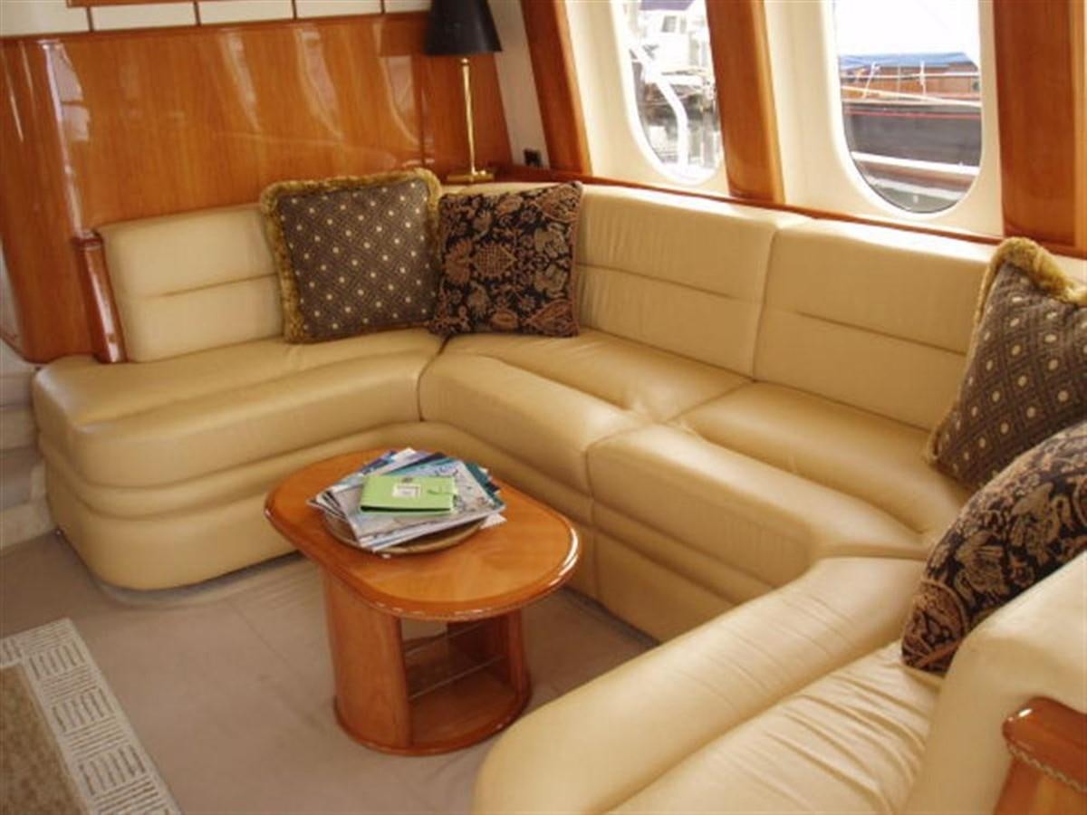 a couch with a coffee table aboard FOREVER SUMMER Yacht for Sale