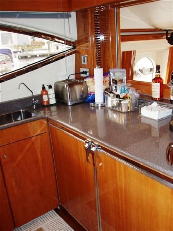 a kitchen with wooden cabinets aboard FOREVER SUMMER Yacht for Sale