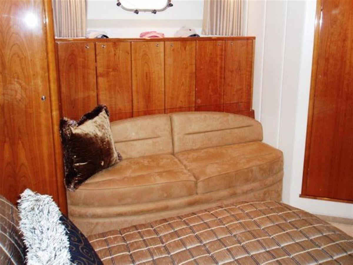 a cat sitting on a couch aboard FOREVER SUMMER Yacht for Sale
