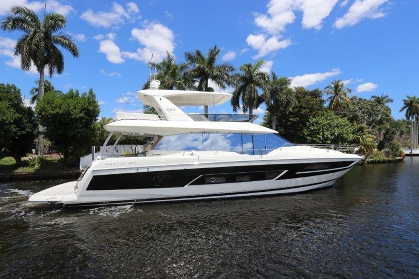 a white yacht on a beach aboard BREATHE EASY Yacht for Sale