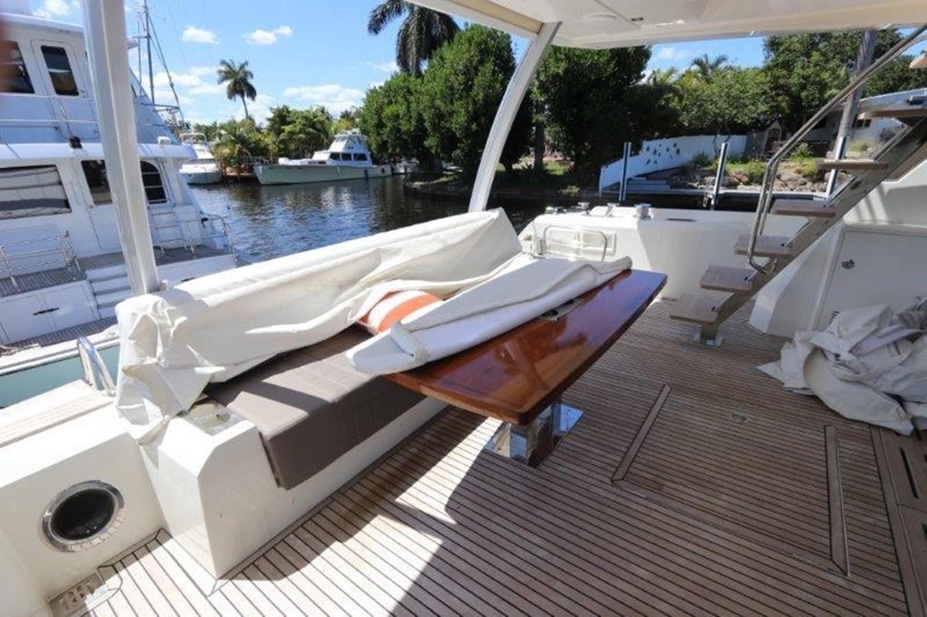 a deck with a chair and a pool aboard BREATHE EASY Yacht for Sale