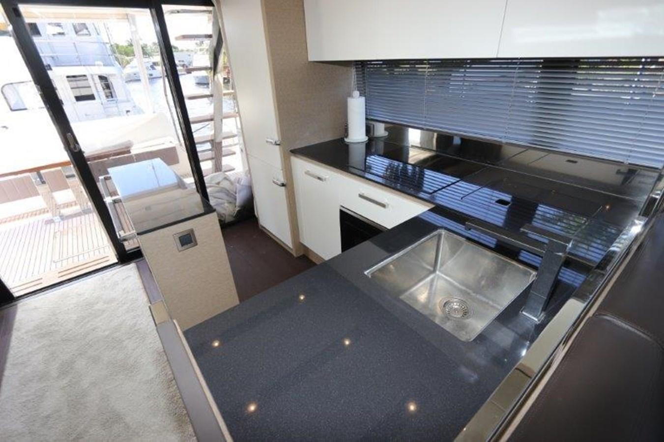 a kitchen with a large glass top aboard BREATHE EASY Yacht for Sale