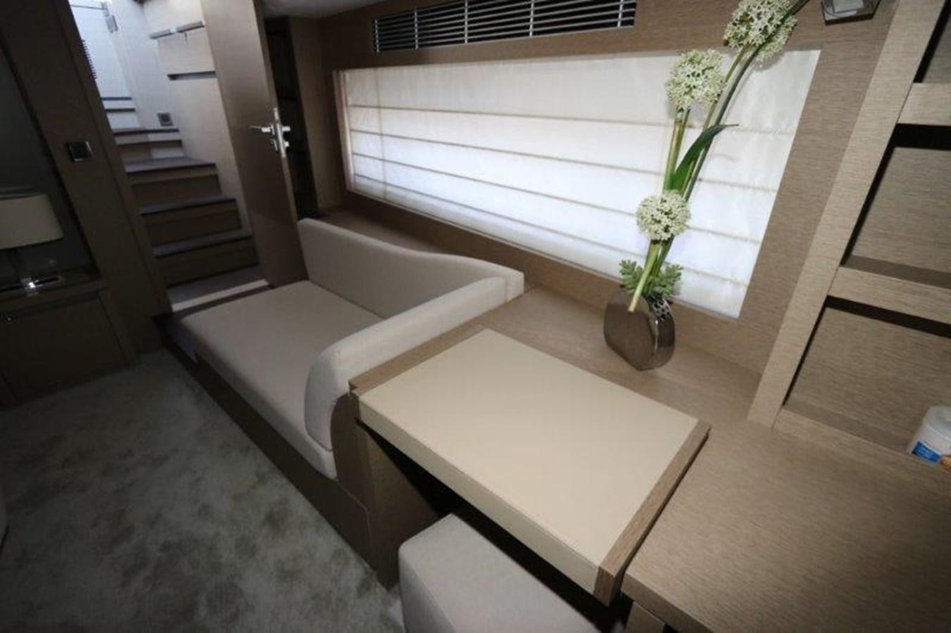 a white couch and a table in a room aboard BREATHE EASY Yacht for Sale