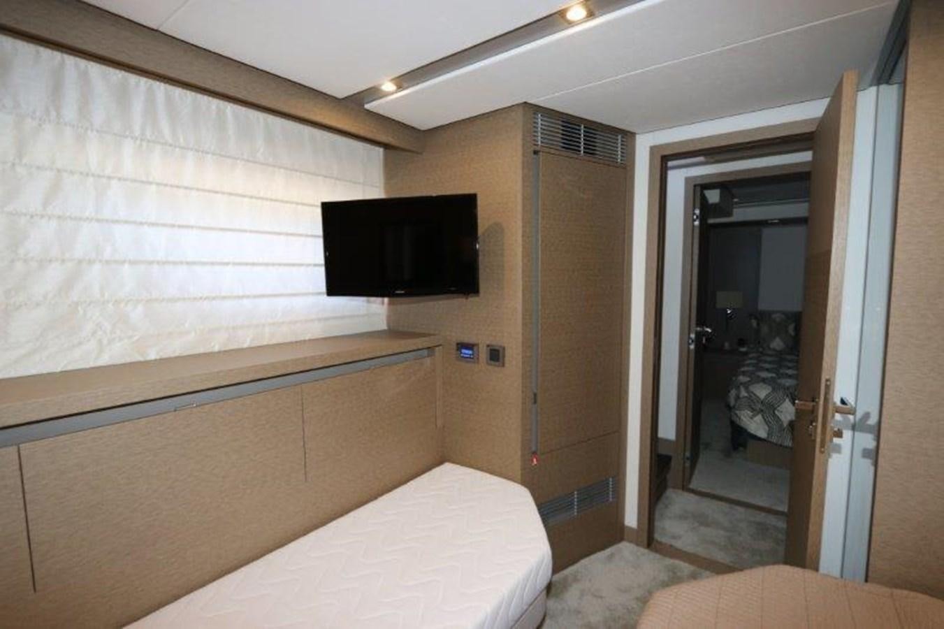 a bedroom with a bed and a television aboard BREATHE EASY Yacht for Sale