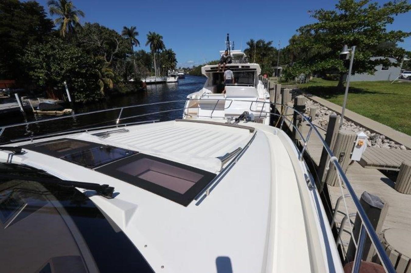 a boat docked at a pier aboard BREATHE EASY Yacht for Sale
