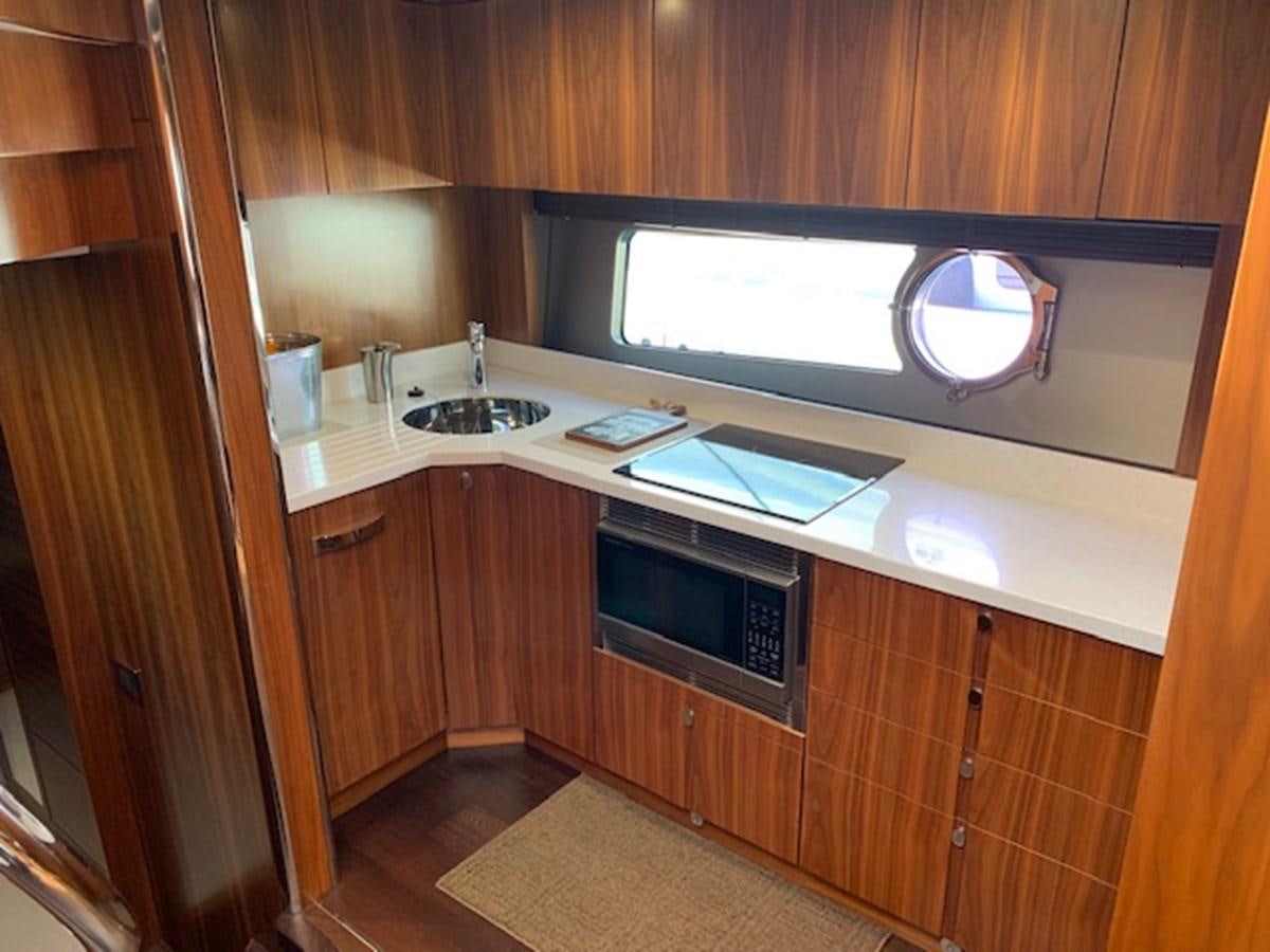 a kitchen with a tv and a sink aboard PIECE OF SHIP Yacht for Sale