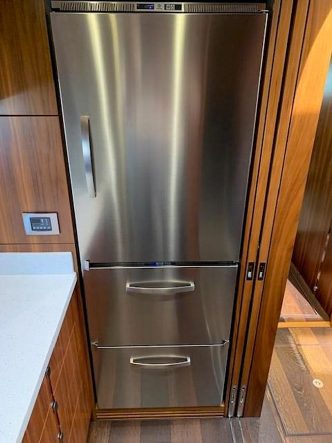 a stainless steel refrigerator in a kitchen aboard PIECE OF SHIP Yacht for Sale