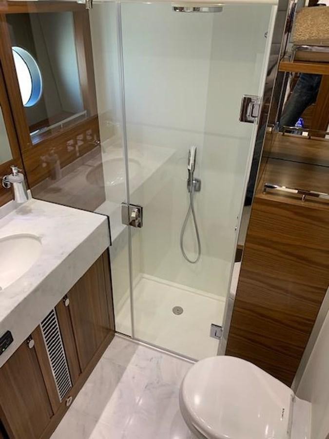 a bathroom with a glass shower door aboard PIECE OF SHIP Yacht for Sale