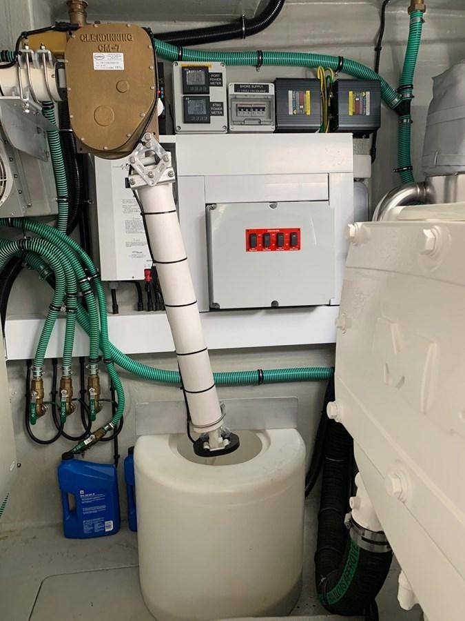 a white toilet with green hoses aboard PIECE OF SHIP Yacht for Sale