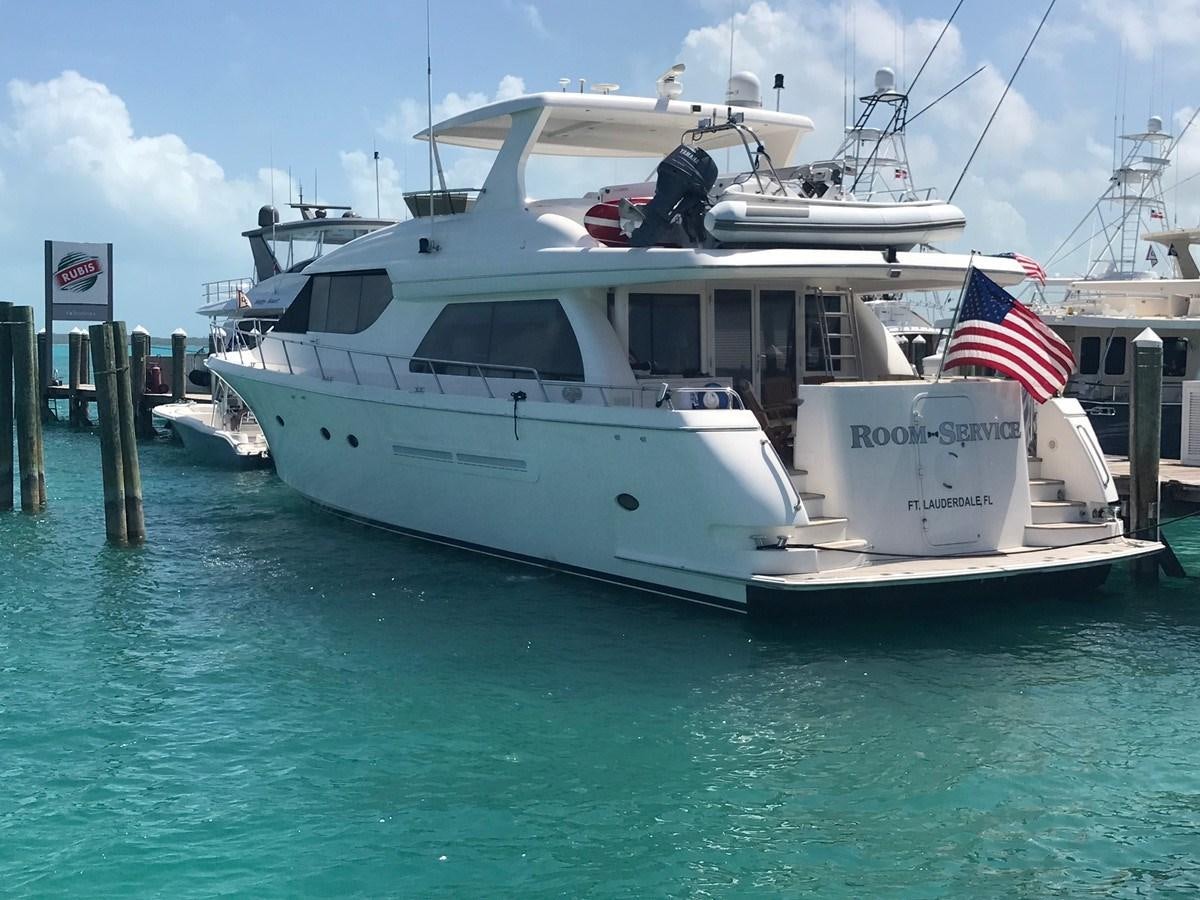 a boat docked at a pier aboard ROOM SERVICE Yacht for Sale