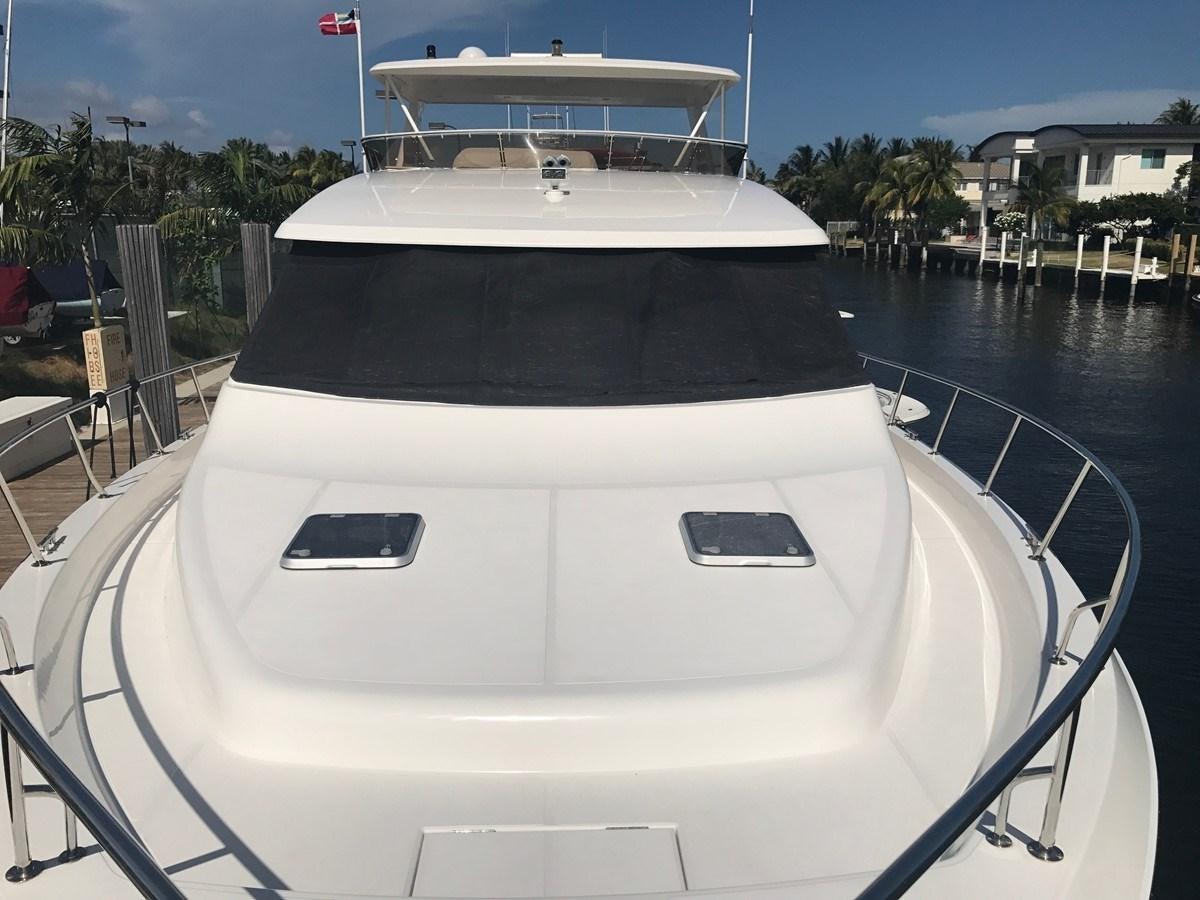 a white yacht on a dock aboard ROOM SERVICE Yacht for Sale