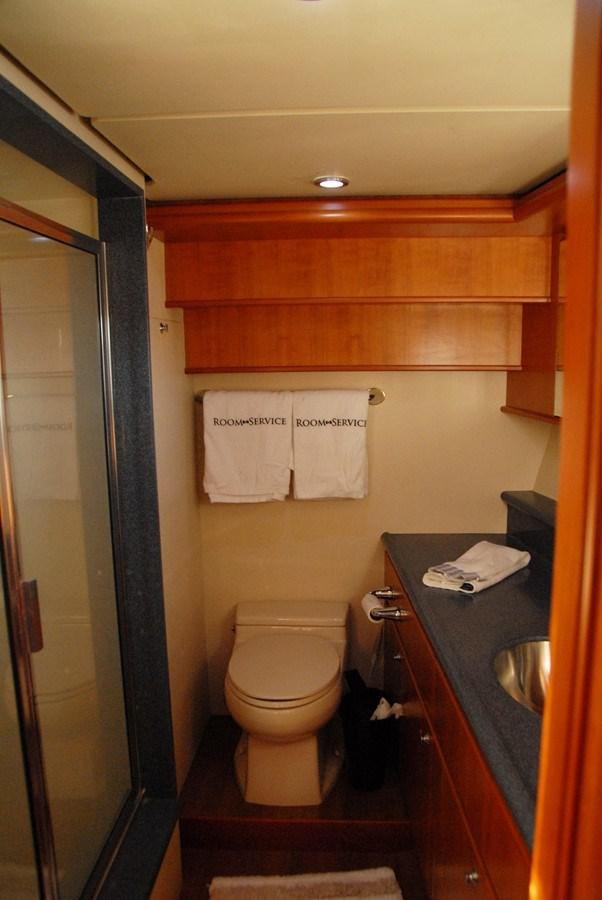 a bathroom with a toilet and a sink aboard ROOM SERVICE Yacht for Sale