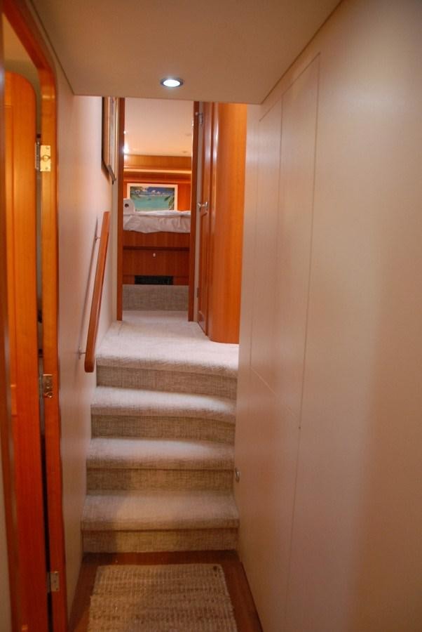 a hallway with a door and a staircase aboard ROOM SERVICE Yacht for Sale