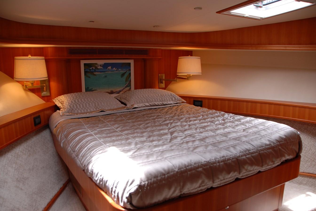 a bed with a white sheet aboard ROOM SERVICE Yacht for Sale