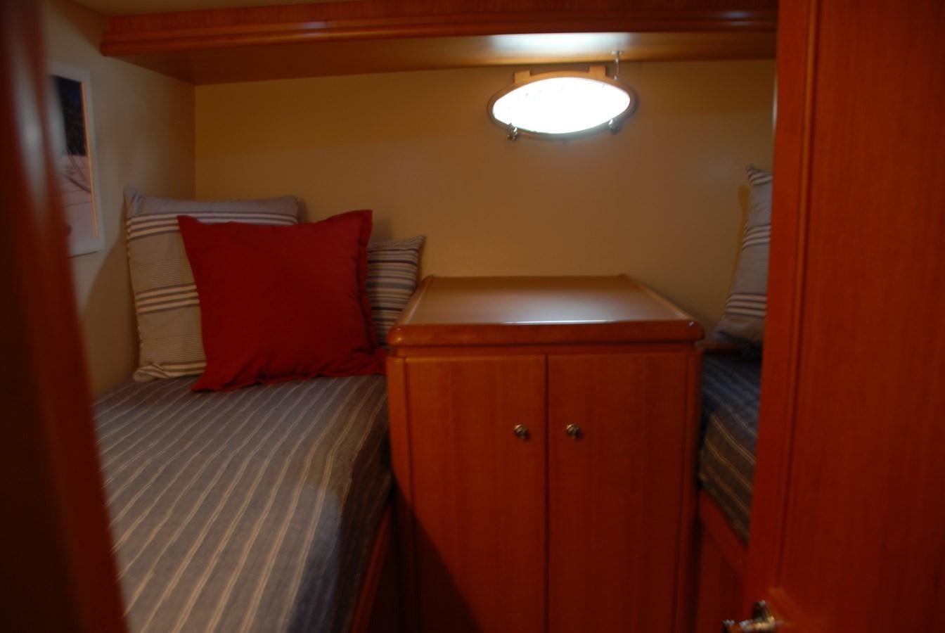 a bed with red pillows aboard ROOM SERVICE Yacht for Sale