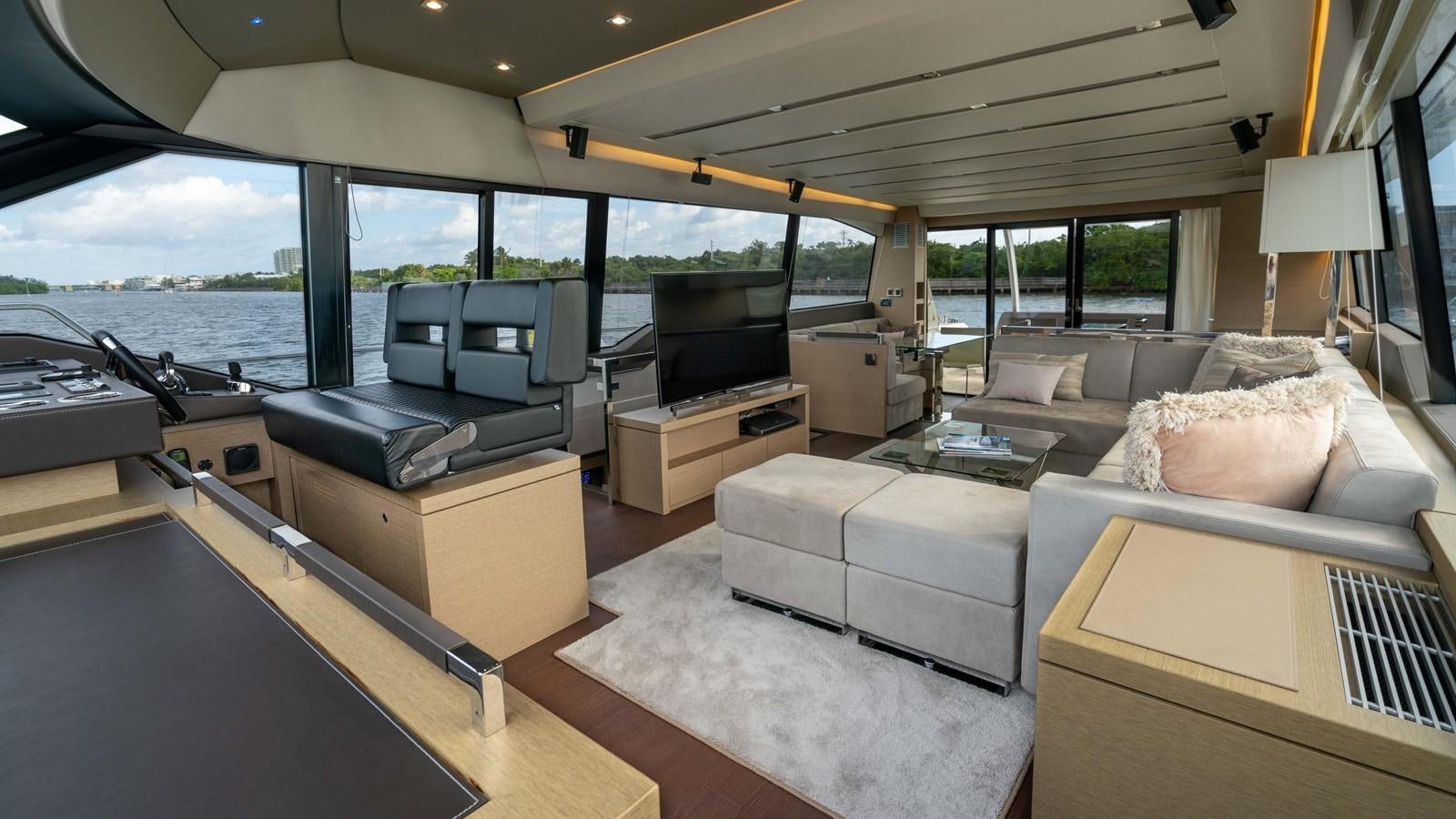 a living room with a large window aboard VIMA Yacht for Sale