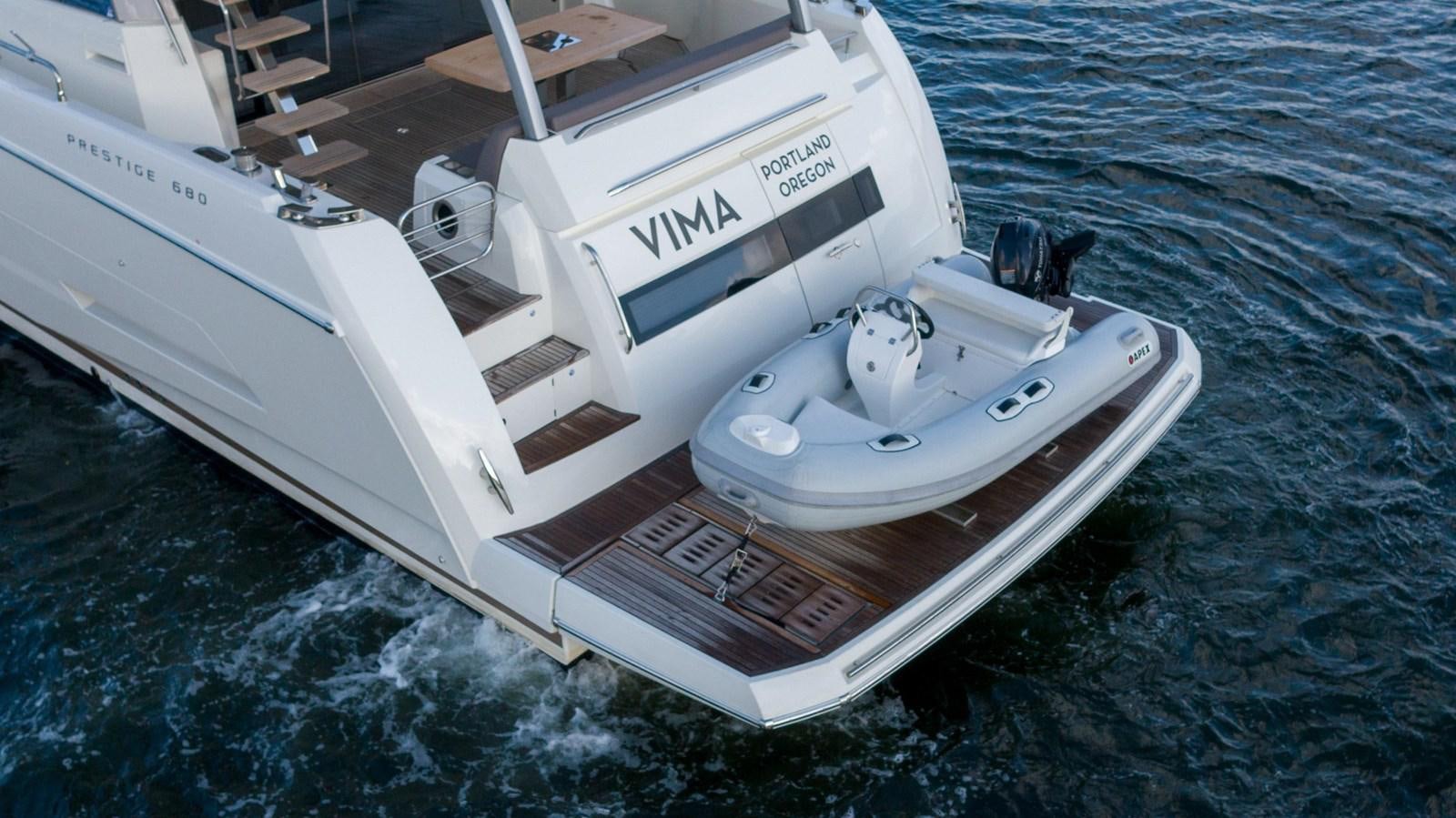 a white boat on the water aboard VIMA Yacht for Sale