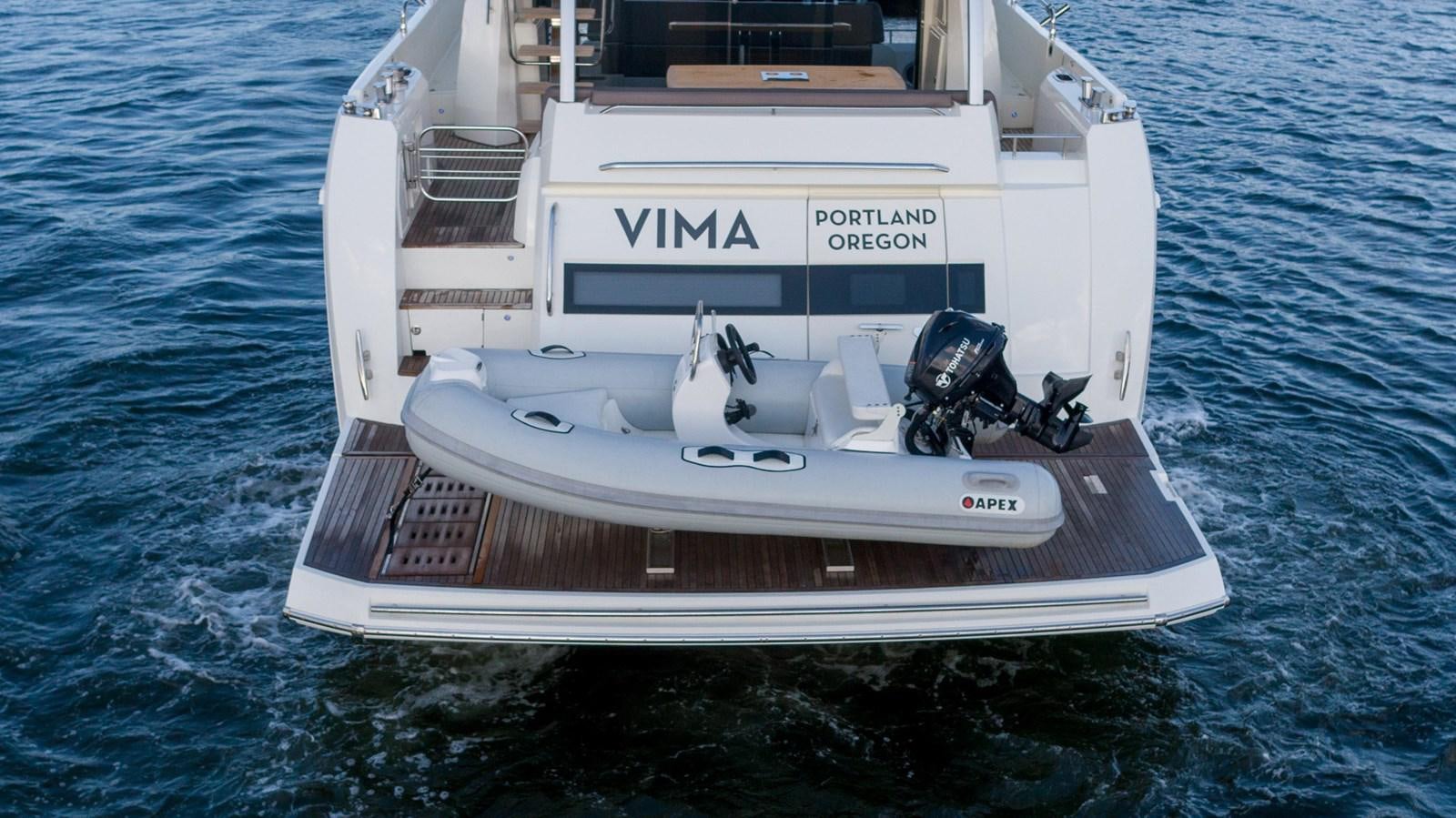 a white boat in the water aboard VIMA Yacht for Sale