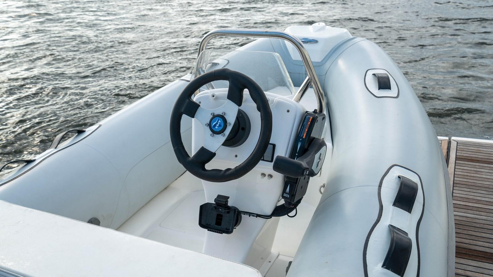the steering wheel of a boat aboard VIMA Yacht for Sale
