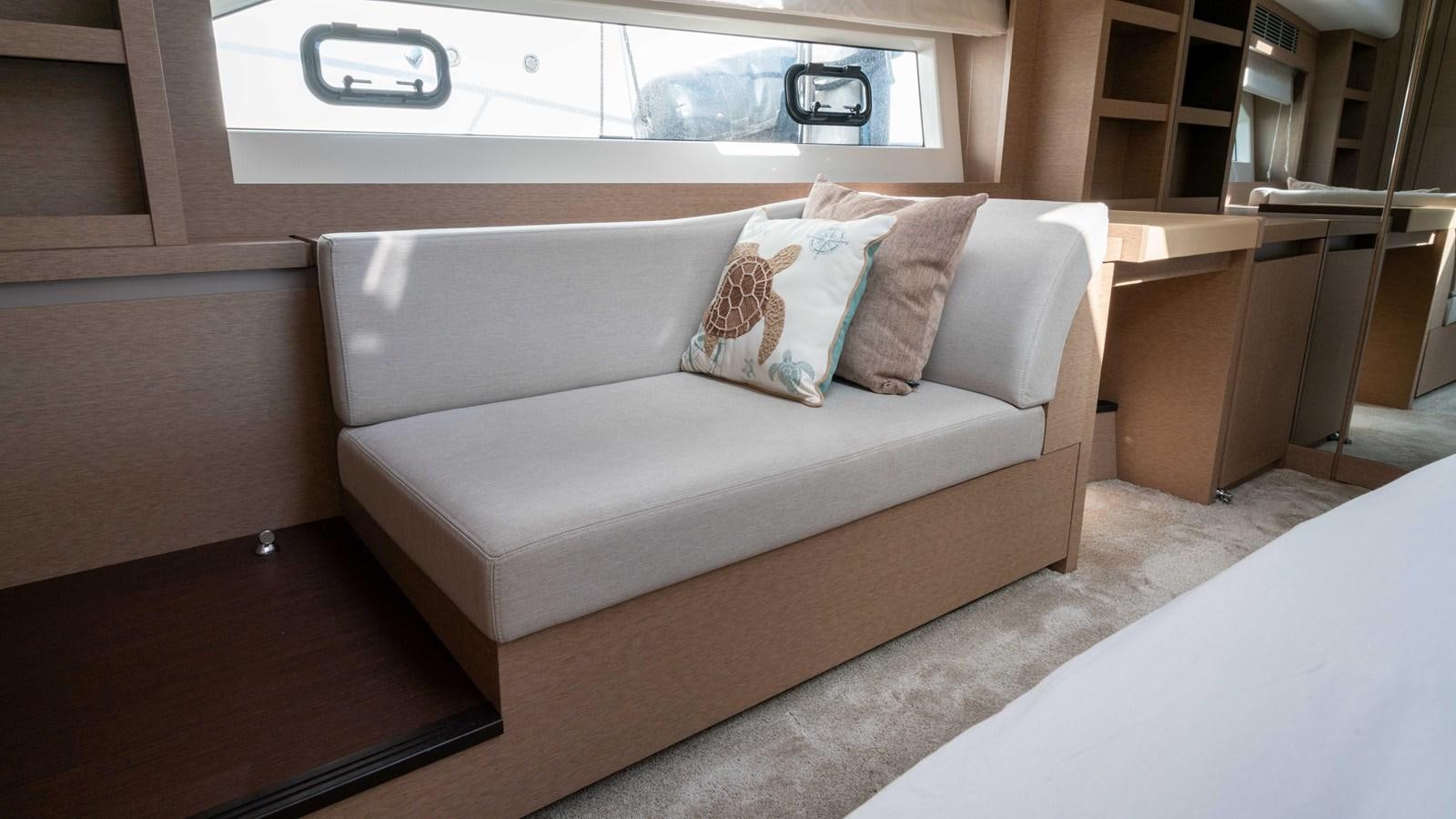 a couch in a room aboard VIMA Yacht for Sale