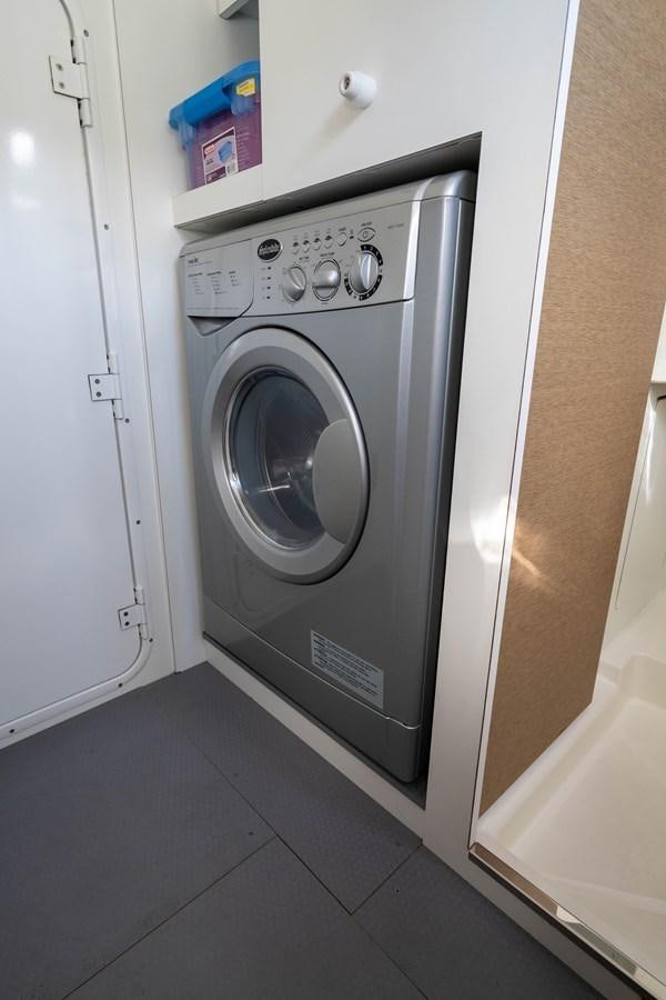 a white washing machine aboard VIMA Yacht for Sale