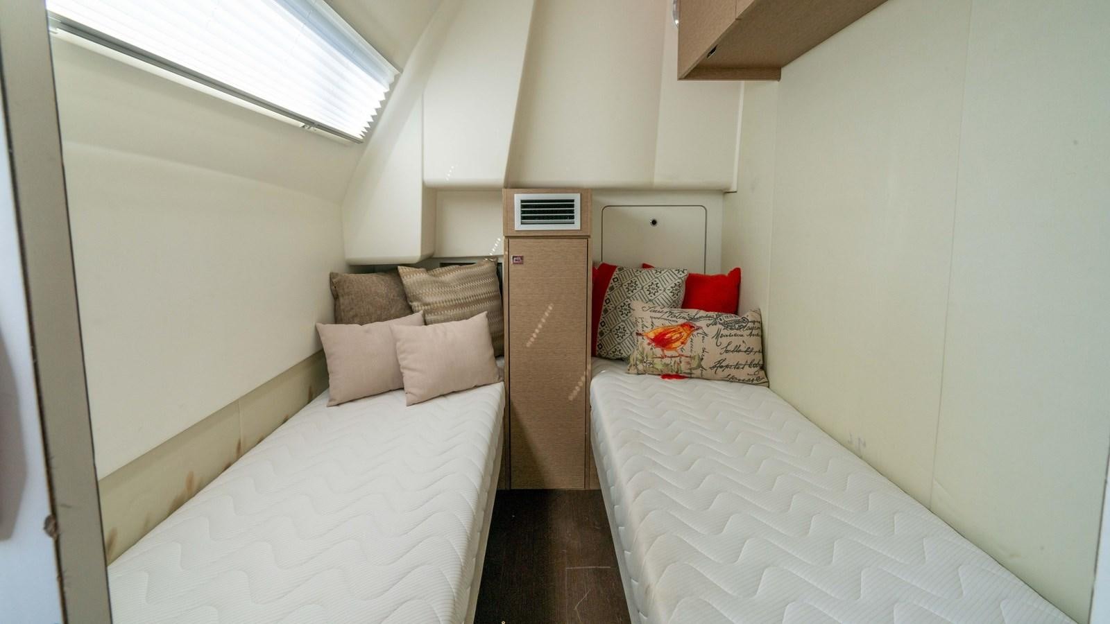 a room with two beds aboard VIMA Yacht for Sale