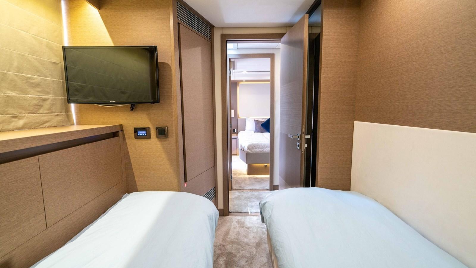 a room with a tv and a bed aboard VIMA Yacht for Sale
