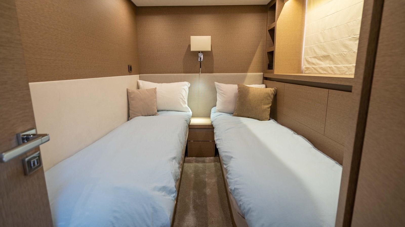 a room with two beds aboard VIMA Yacht for Sale