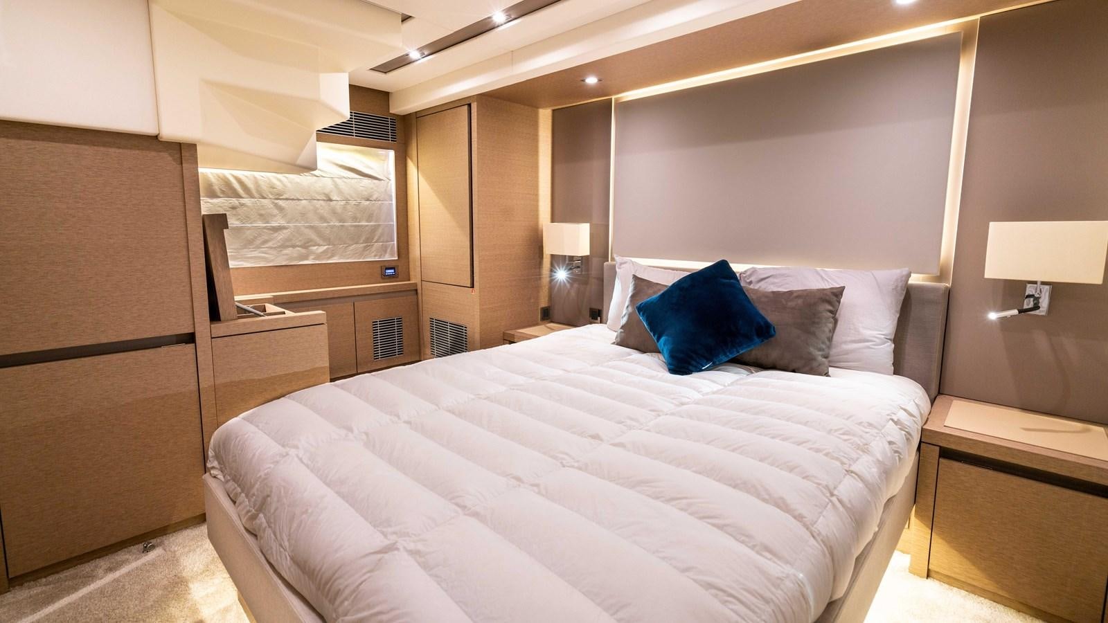 a room with a bed and a desk aboard VIMA Yacht for Sale