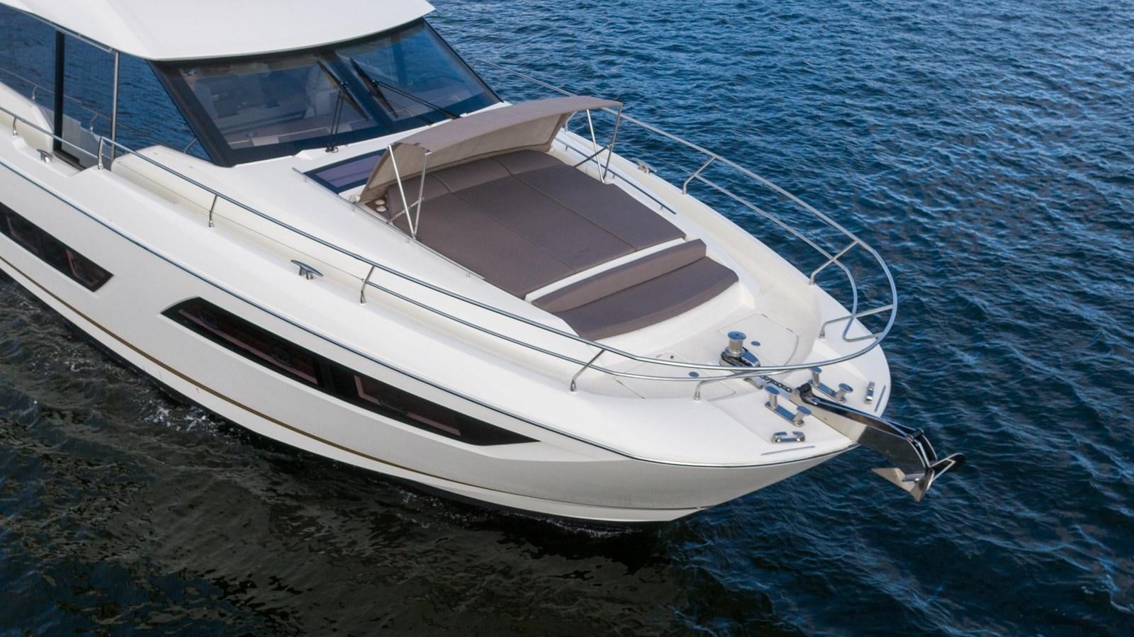 a white boat on the water aboard VIMA Yacht for Sale